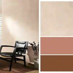 Gemütliche Wandfarbe kombinieren: Ein schwarzer Ledersessel vor einer hellbeigen Wand, daneben Farbfelder in Beige, Rosé und Braun.