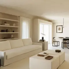 Minimalist Wohnzimmer mit weißem Sofa, Beistelltischen und Essbereich. Ein Beispiel für einen modernen Lebensstil, der Ruhe und Ordnung ausstrahlt.