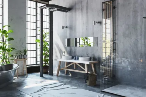 Badezimmer im bad industrielook mit Betonwänden, freiliegenden Rohren, einer Metallbadewanne und Pflanzen.