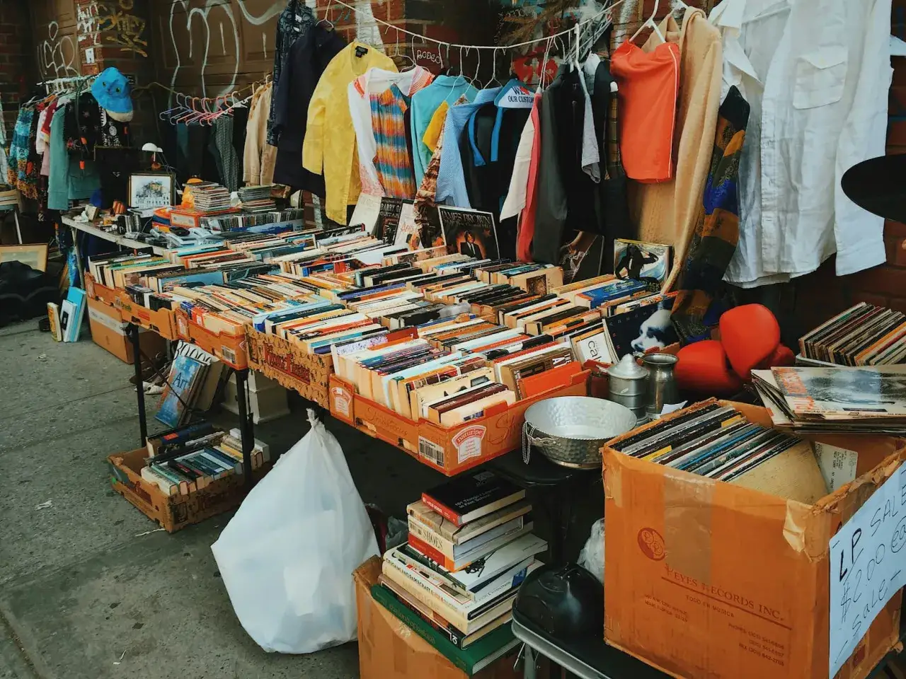 B&uuml;cher, Schallplatten und Kleidung auf einem Flohmarkt. Eine perfekte Flohmarkt-Checkliste f&uuml;r Schn&auml;ppchenj&auml;ger.